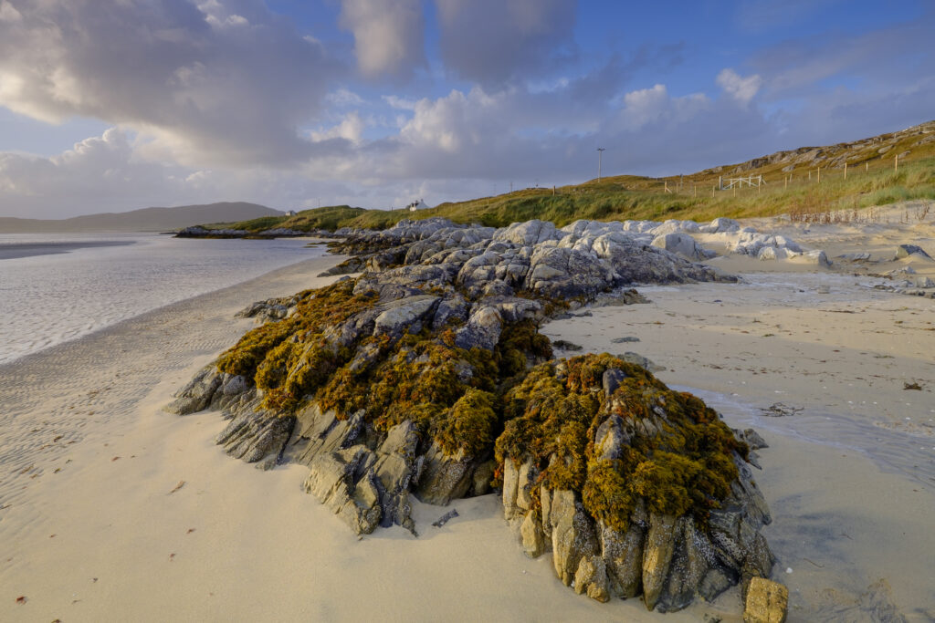 Scotland, The Isle of Harris, Luskentyre Bay. Late afternoon light illuminates the rocky coastline of the Luskentyre Bay on the Luskentyre peninsula.