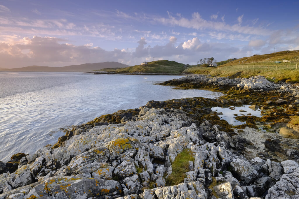 Scotland, The Isle of Harris, Luskentyre Bay. Late afternoon light illuminates the rocky coastline of the Luskentyre Bay on the Luskentyre peninsula.