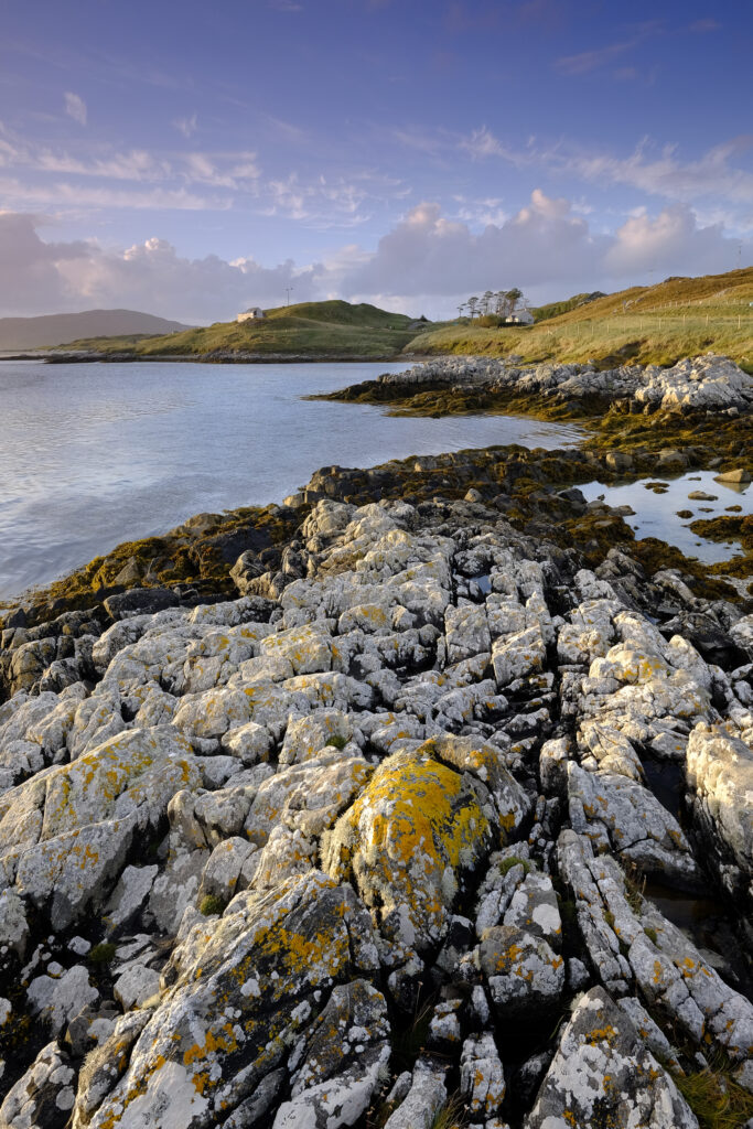 Scotland, The Isle of Harris, Luskentyre Bay. Late afternoon light illuminates the rocky coastline of the Luskentyre Bay on the Luskentyre peninsula.