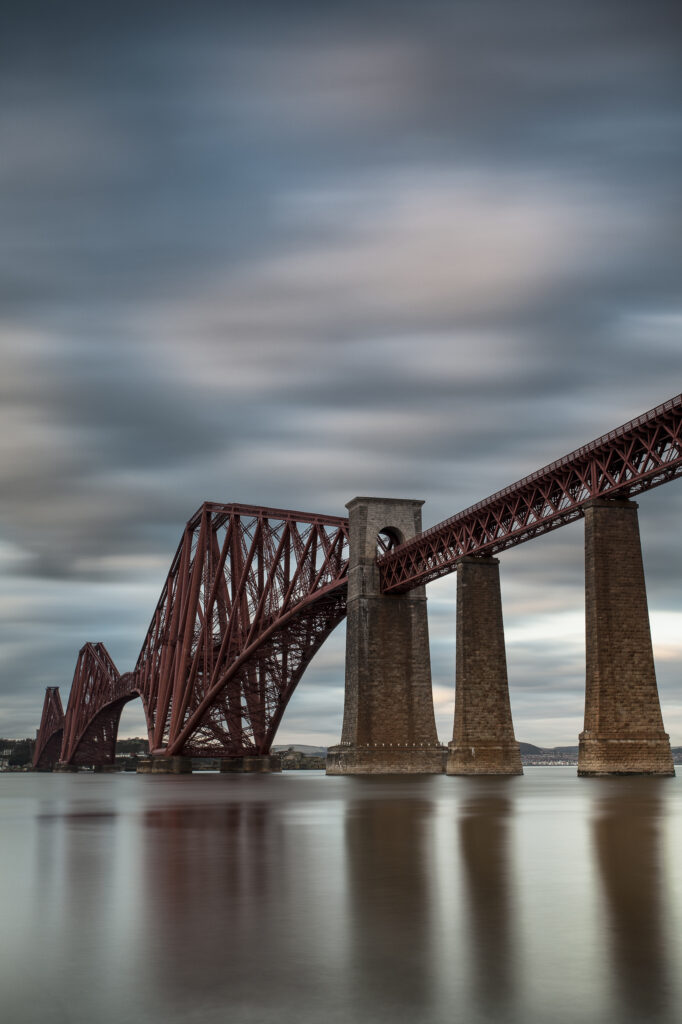 Scotland, Edinburgh, Forth Bridge. Forth Railway Bridge connecting Scotland's capital city, Edinburgh, with Fife, leaving the Lothians at Dalmeny and arriving in Fife at North Queensferry.