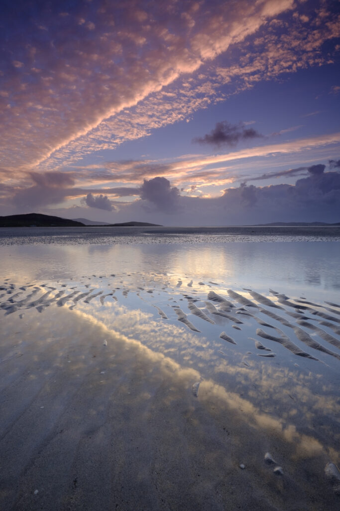 Scotland, The Isle of Harris, Seilebost. Sunset over the Lusketyre Bay on the Luskentyre peninsula looking towards Seilebost.