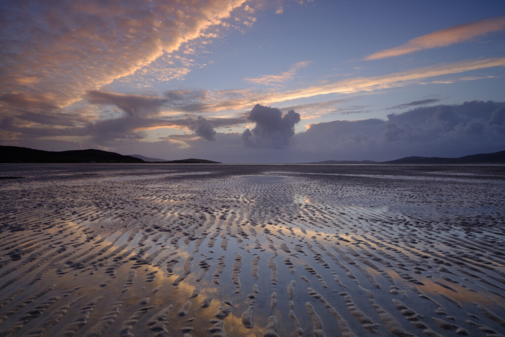 Scotland, The Isle of Harris, Seilebost. Sunset over the Lusketyre Bay on the Luskentyre peninsula looking towards Seilebost.