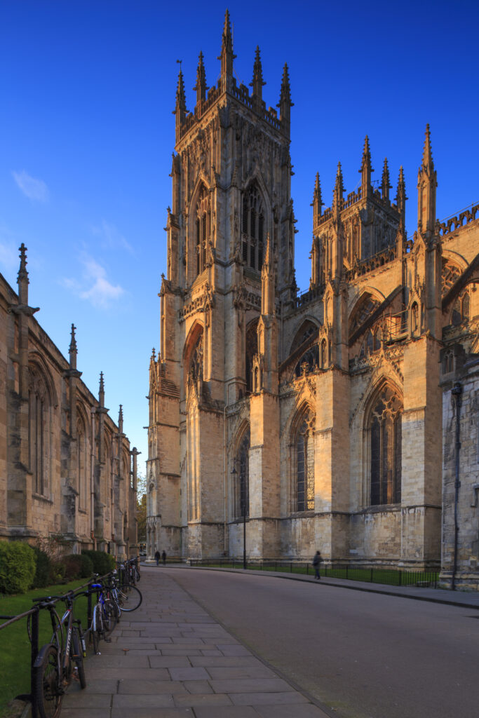 England, North Yorkshire, York City. St Michael le Belfrey and the York Minster - The cathedral which dominates the York skyline.