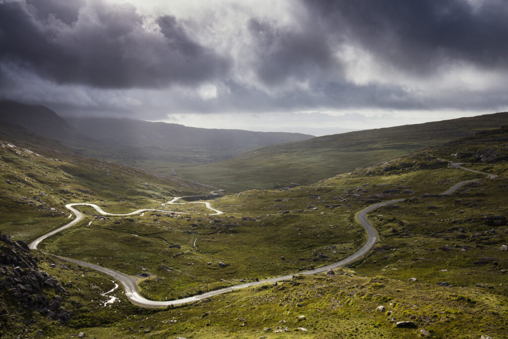 Republic of Ireland, County Cork, Healy Pass. The serpentine R574 road viewed from Healy Pass, a mountain pass in the Caha mountain range, located in the Beara peninsula.