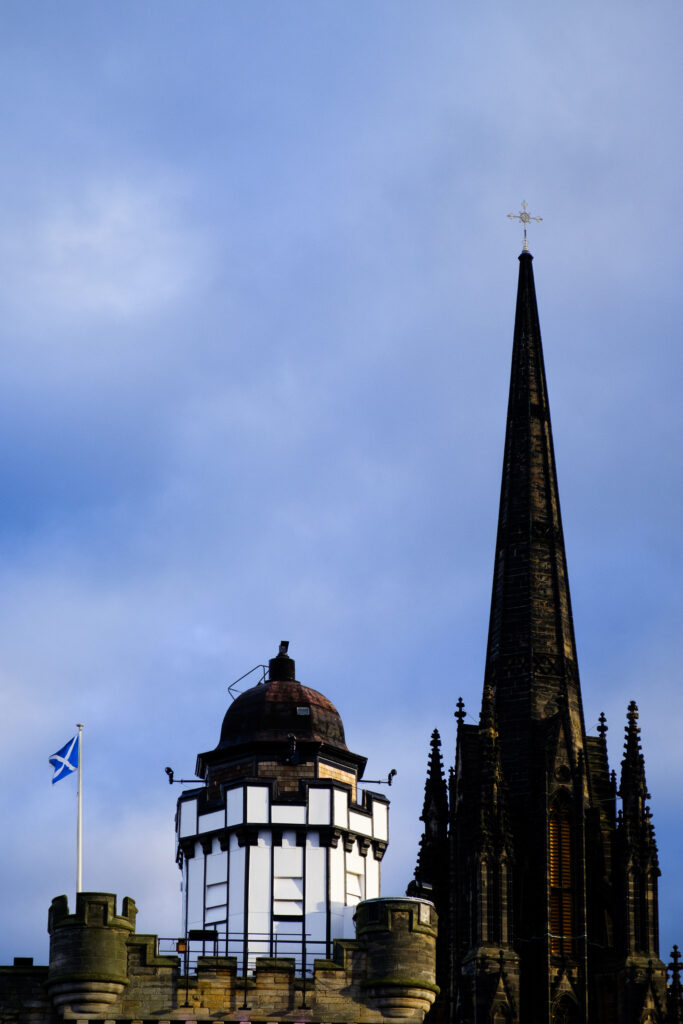 Scotland, Edinburgh, The Royal Mile. The Camera Obscura with The Hub in the background. Originally known as the Assembly Hall, this historic landmark of the Royal Mile is a grade A listed building constructed between 1842 and 1845.