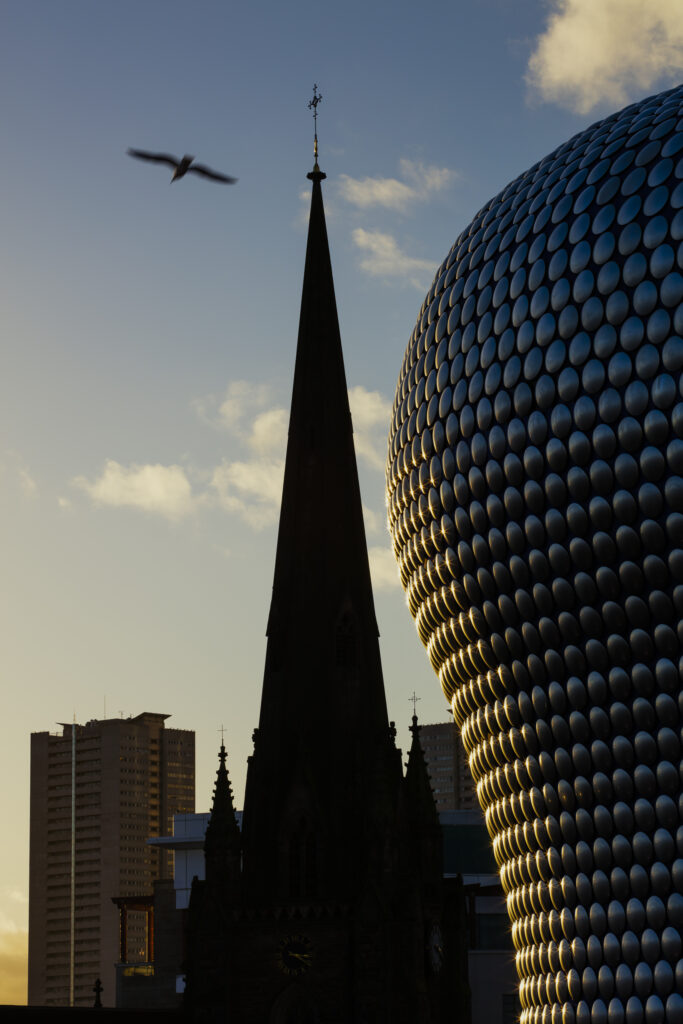 England, West Midlands, Birmingham City. Abstract shapes of the new, modern Selfridges building, alongside the old St Martins Church.