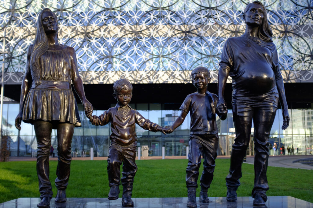 England, West Midlands, Birmingham City. A statue named 'A Real Birmingham Family' by Gillian Wearing, located in front of the new Birmingham Library.
