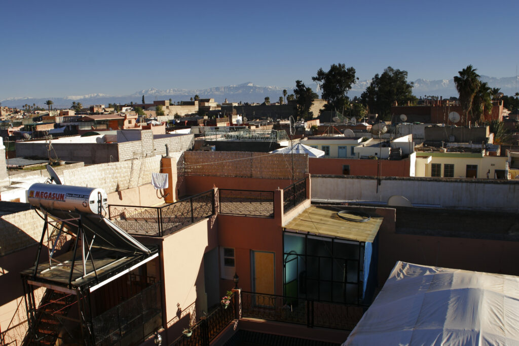 Morocco, Central Morocco, Marrakesh. View looking from a city terrace across the roofs, terraces and city skyline.