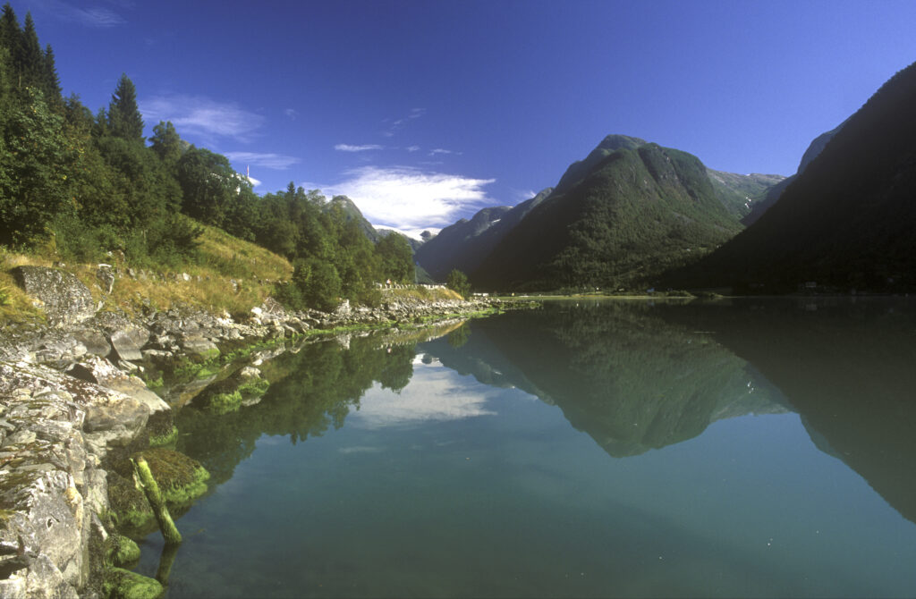 NORWAY, Sogn Og Fjordane, Fjaerland. Mt Middagshaugen reflected in the still waters of Fjaerlandsfjordan