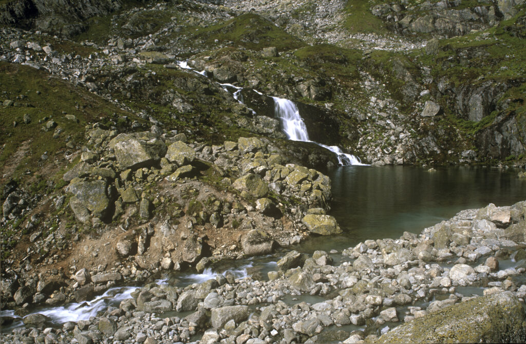 NORWAY, Sogn Og Fjordane, Jostedalsbreen National Park. The fast flowing waterfall running downstream of Flatbreen Glacier