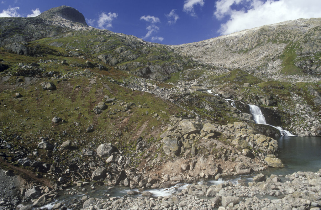 NORWAY, Sogn Og Fjordane, Jostedalsbreen National Park. The fast flowing waterfall running downstream of Flatbreen Glacier