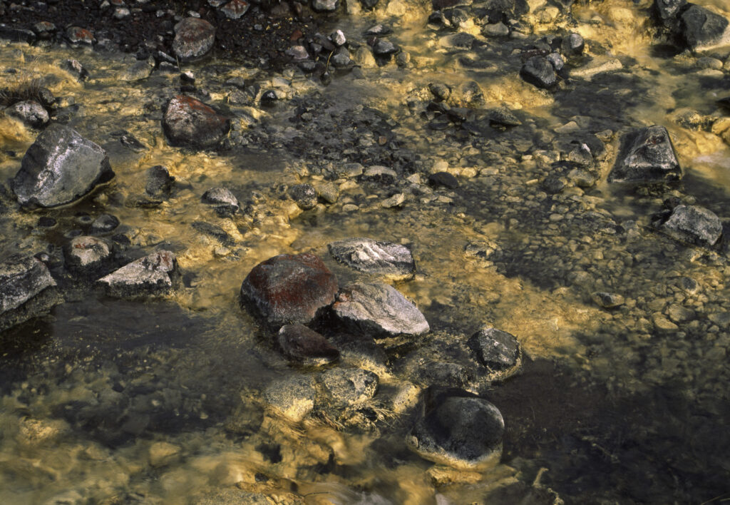 NEW ZEALAND, Central Plateau, Tongariro National Park. The golden waters of Silica rapids formed by Silica mineral deposits
