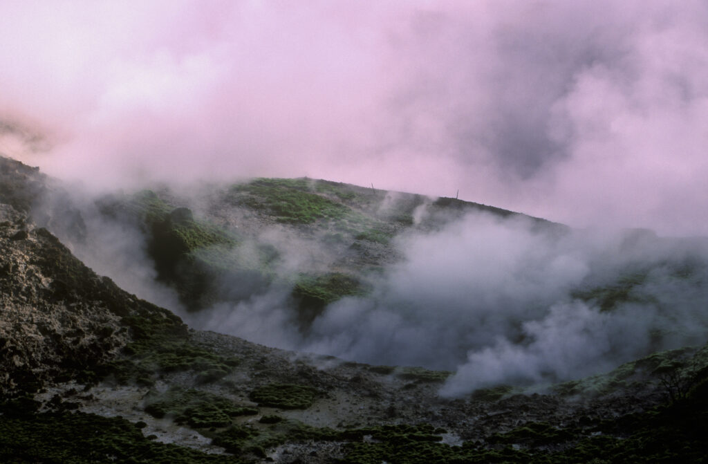 NEW ZEALAND, Central Plateau, Wairakei. Steaming crater created by thermal activity at the craters of the moon scenic reserve
