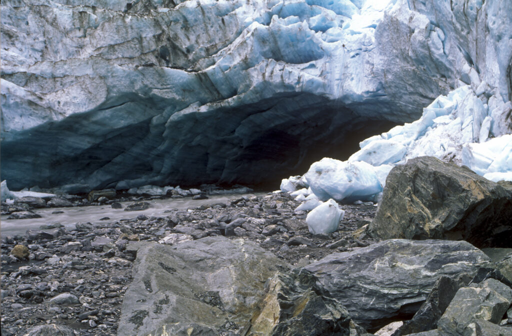 NEW ZEALAND, West Coast, Westland National Park. Huge deposited rocks and the river formed from the Franz Josef Glacier.