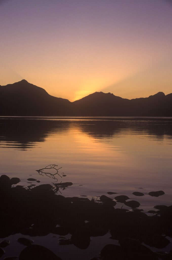 NEW ZEALAND, Southland, Lake Te Anau. Sunset over the mountainous peaks of Fiordland National Park