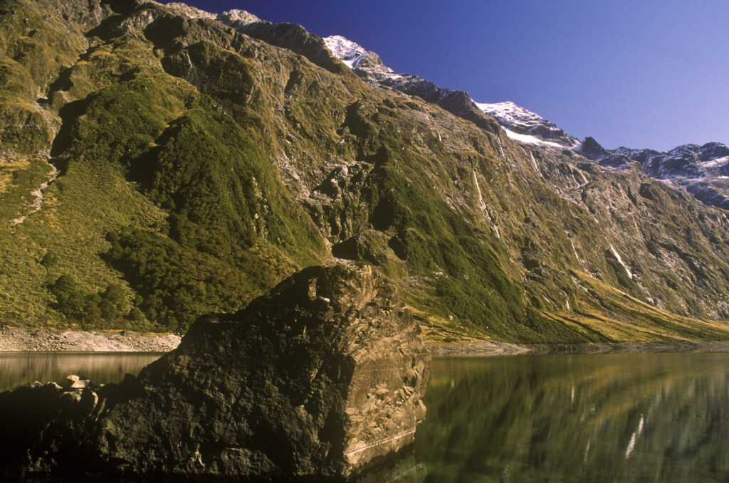 NEW ZEALAND, Southland, Fiordland National Park. The Darran mountain range reflected in the still waters of Lake Marian