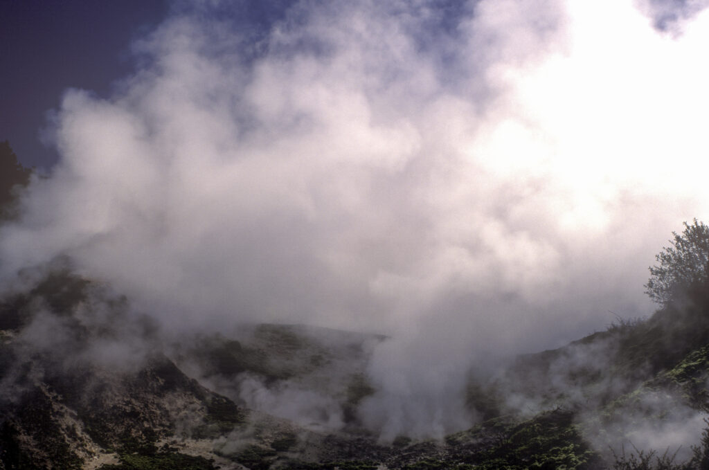NEW ZEALAND, Central Plateau, Wairakei. Steaming crater created by thermal activity at the craters of the moon scenic reserve