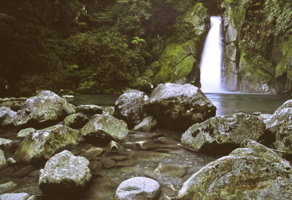NEW ZEALAND, Southland, Fiordland National Park. Giant Gate Falls, a spectacular waterfall on the world famous 'Milford Track'