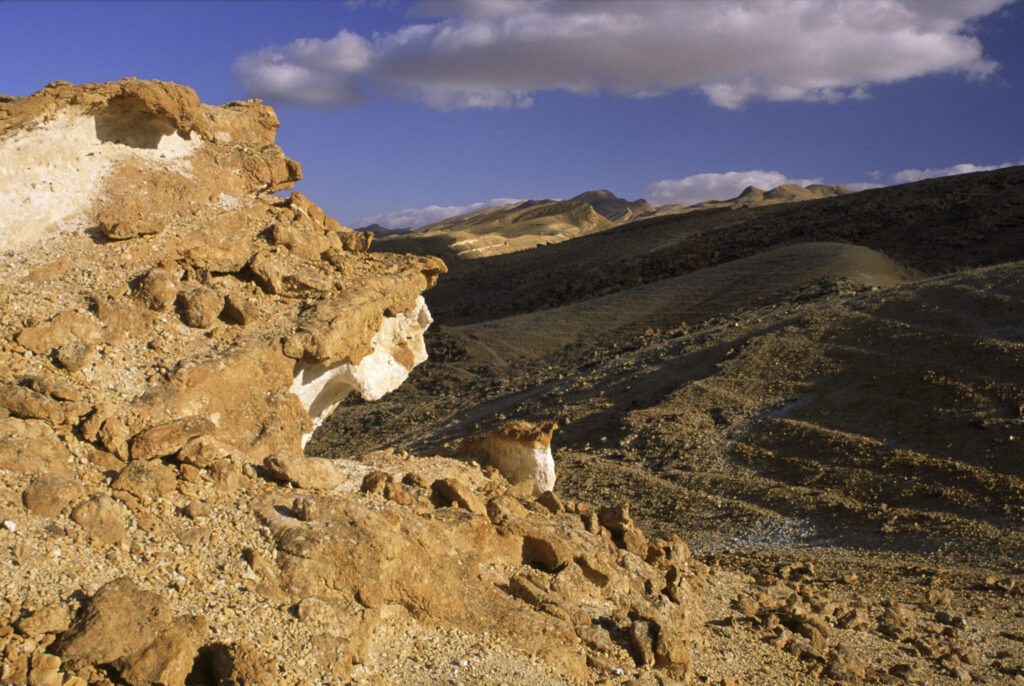 TUNISIA, Chebika Region, Tamerza. A spectacular rock formation overlooks the harsh mountain landscape surrounding the town.