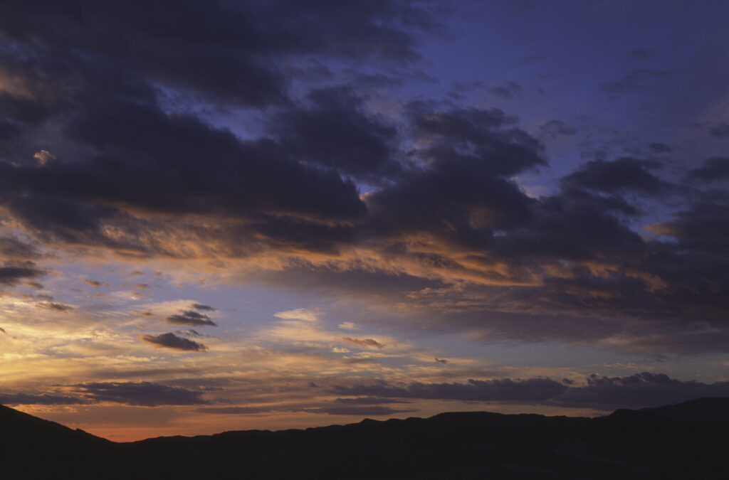 TUNISIA, Chebika Region, Tamerza. The colours of a sunset behind the mountainous landscape found near to the town.