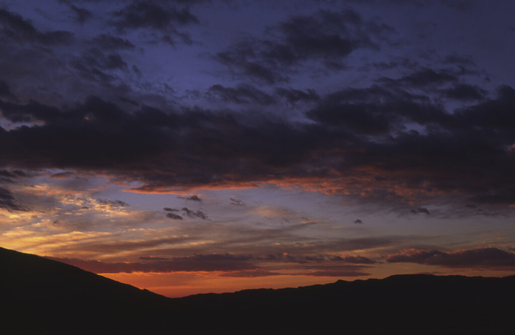 TUNISIA, Chebika Region, Tamerza. The colours of a sunset behind the mountainous landscape found near to the town.