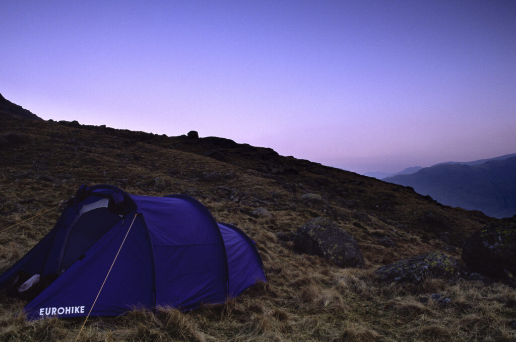 ENGLAND, Cumbria, Lake District National Park. Wild camping on Martcrag Moor, photograped at dusk near the Cumbria Way Track.