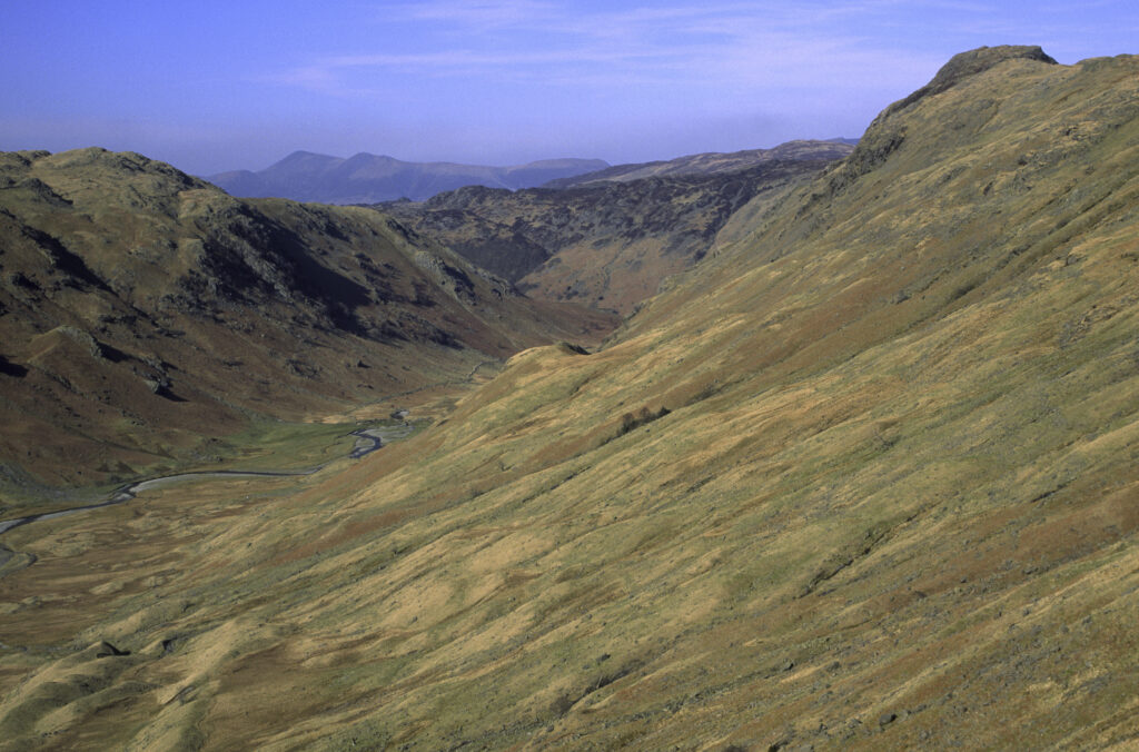ENGLAND, Cumbria, Lake District National Park. Langstrath Beck running through the landscape of Stonethwaite Fell along the Cumbria Way track.