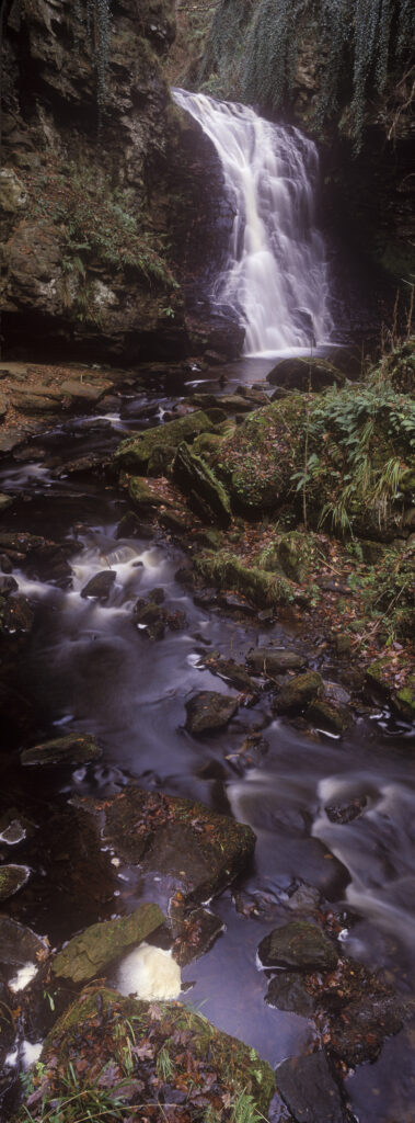 ENGLAND, Northumberland, Bellingham. The flowing waterfall of Hareshaw Linn, a popular spot located within Northumberland National Park