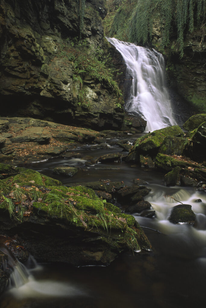 ENGLAND, Northumberland, Bellingham. The flowing waterfall of Hareshaw Linn a popular spot located within Northumberland National Park.