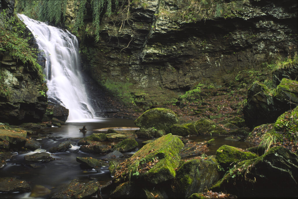 ENGLAND, Northumberland, Bellingham. The flowing waterfall of Hareshaw Linn a popular spot located within Northumberland National Park.