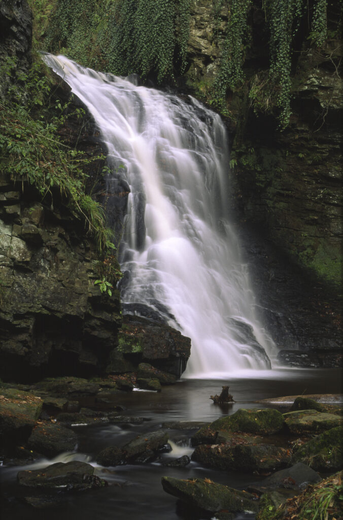 ENGLAND, Northumberland, Bellingham. The flowing waterfall of Hareshaw Linn a popular spot located within Northumberland National Park.