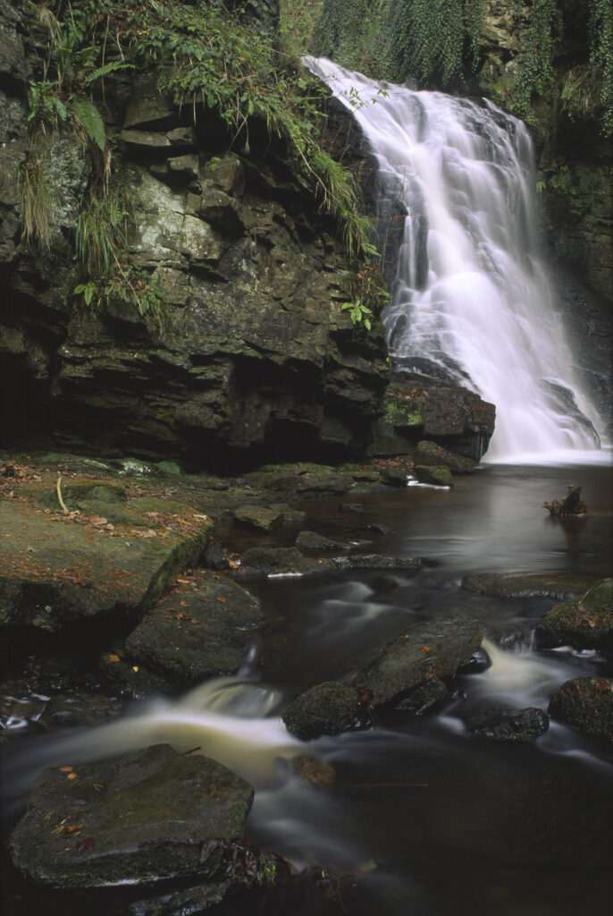 ENGLAND, Northumberland, Bellingham. The flowing waterfall of Hareshaw Linn a popular spot located within Northumberland National Park.