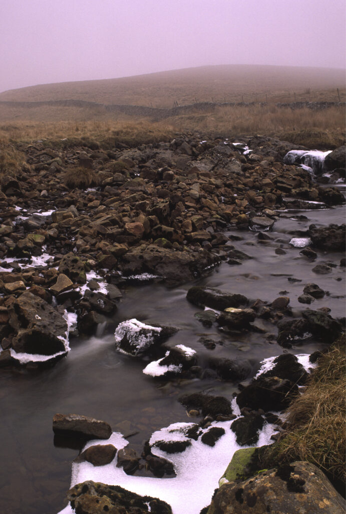 ENGLAND, Yorkshire, Yorkshire Dales National Park. A stream flowing through the hills above horton in ribblesdale
