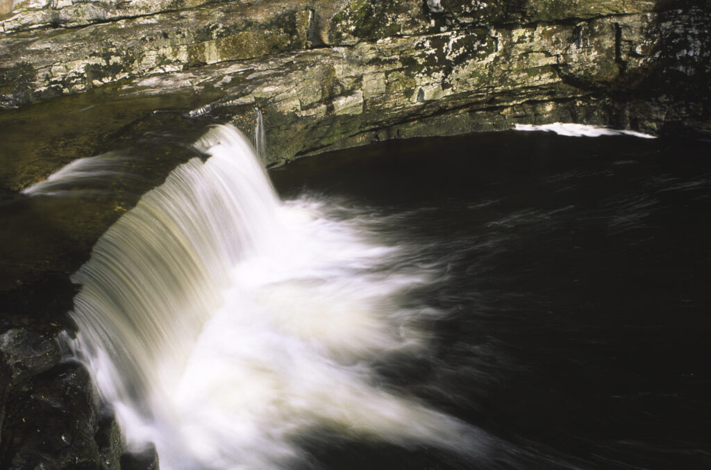 ENGLAND, Yorkshire, Yorkshire Dales National Park. The flowing waters of Stainforth Force
