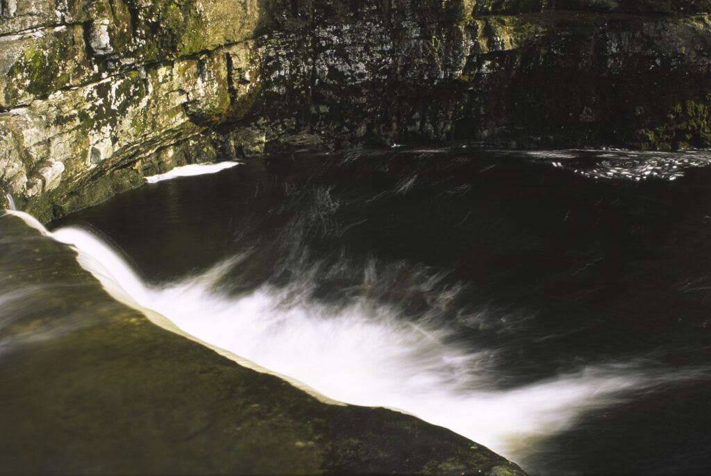 ENGLAND, Yorkshire, Yorkshire Dales National Park. The flowing waters of Stainforth Force