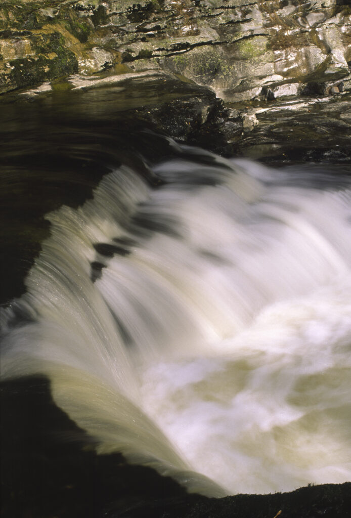 ENGLAND, Yorkshire, Yorkshire Dales National Park. The flowing waters of Stainforth Force
