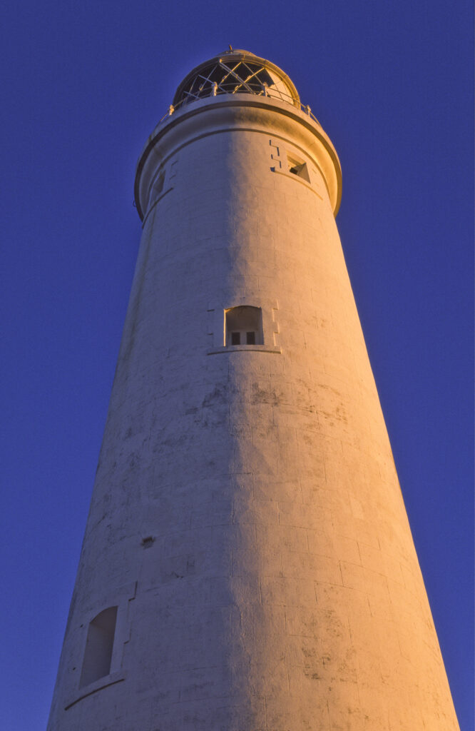 ENGLAND, Tyne & Wear, St Marys Island. Warm evening sun illuminates the popular whitley bay landmark of the lighthouse