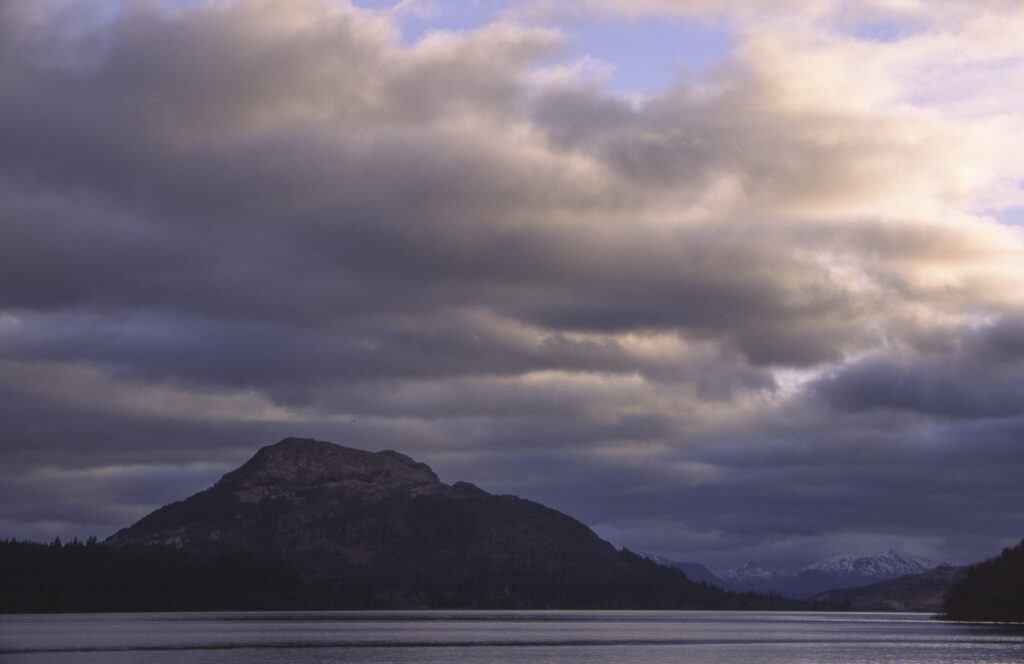 SCOTLAND, Scottish Highlands, Loch Laggan. A storm clears behind the peaks surrounding the still waters of the loch.