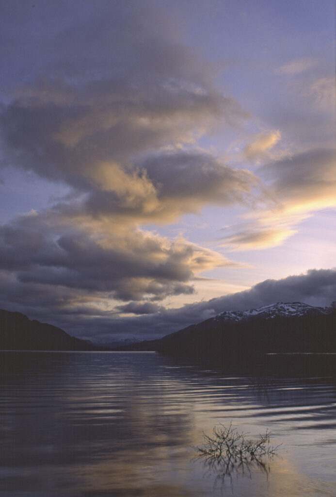 SCOTLAND, Scottish Highlands, Loch Laggan. A storm clears behind the peaks surrounding the still waters of the loch.