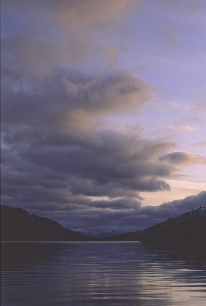 SCOTLAND, Scottish Highlands, Loch Laggan. A storm clears behind the peaks surrounding the still waters of the loch.