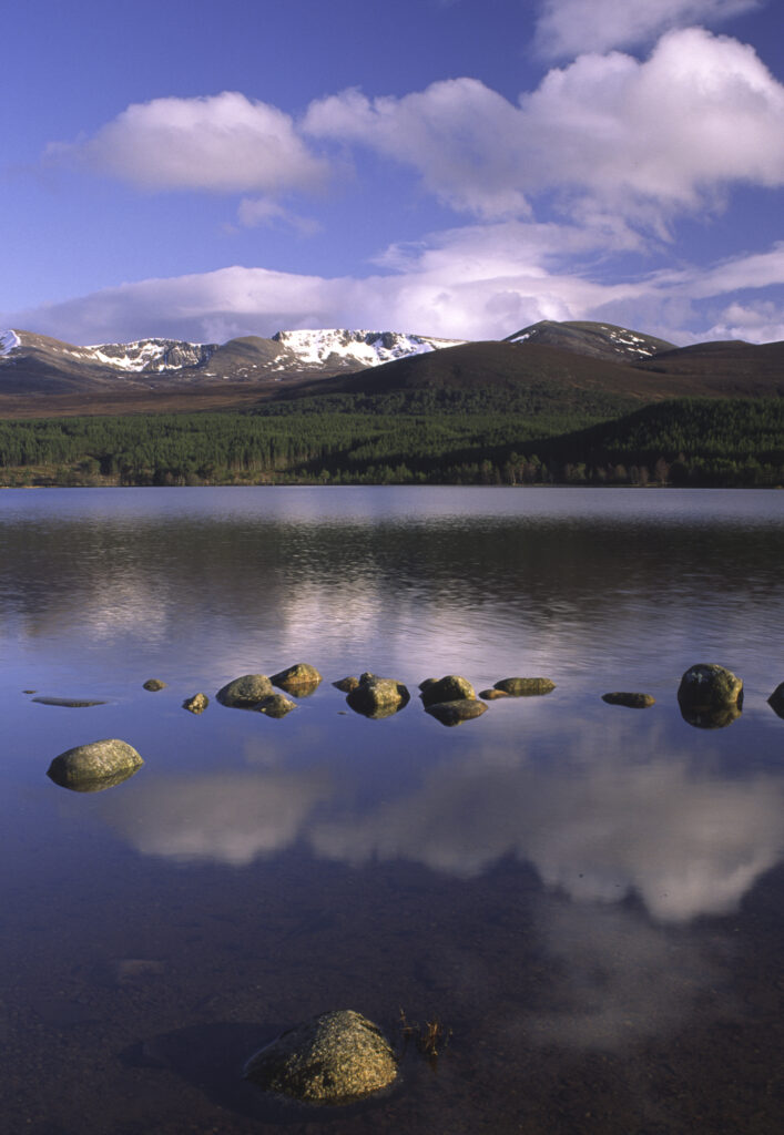 SCOTLAND, Scottish Highlands, Cairngorms National Park. The Cairngorm mountain range reflected in still waters of Loch Morlich