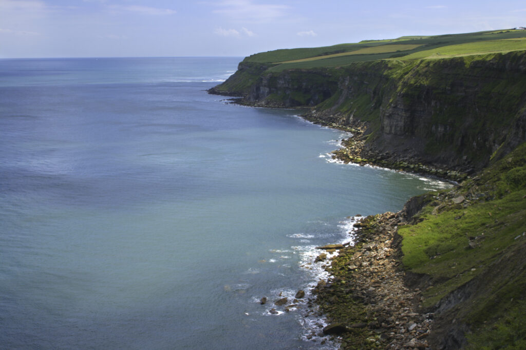 ENGLAND, Yorkshire, North York Moors National Park. A typical example of the sweeping coastline to be found near Whitby