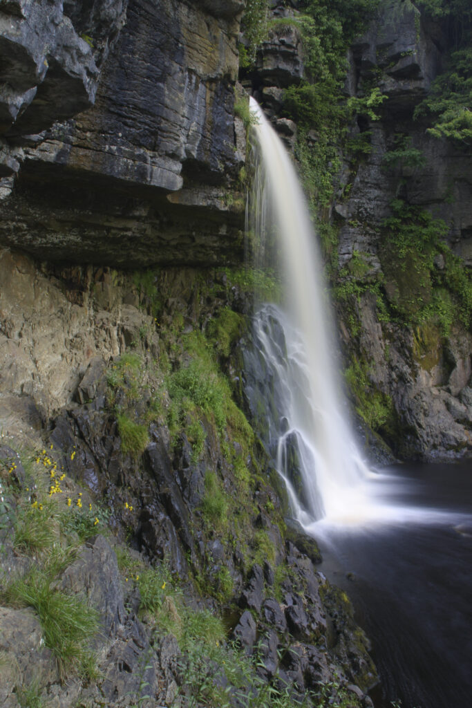 ENGLAND, Yorkshire, Yorkshire Dales National Park. The fast flowing waters of the Thornton Force waterfall, near Ingleton.