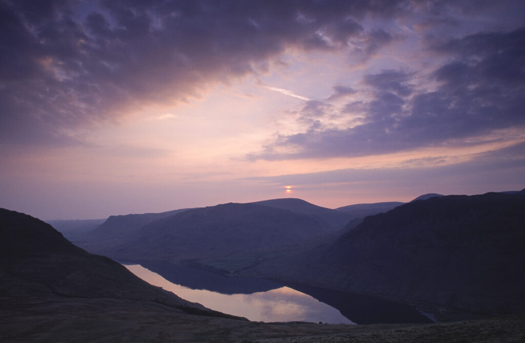 ENGLAND, Cumbria, Lake District National Park. Sunset reflected in the still waters of Wast Water Englands deepest lake