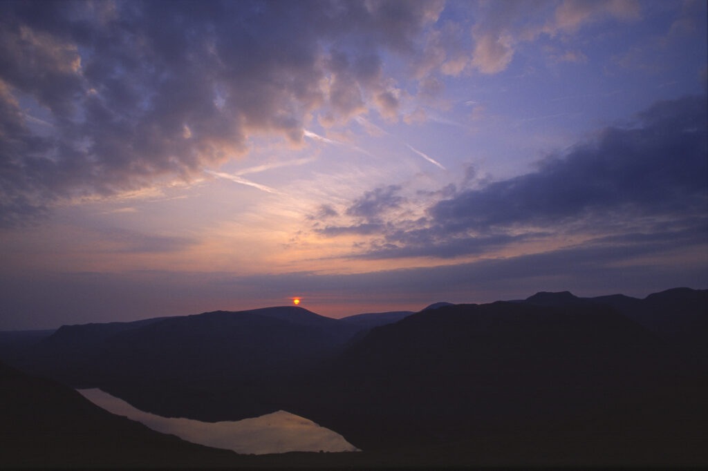 ENGLAND, Cumbria, Lake District National Park. Sunset reflected in the still waters of Wast Water Englands deepest lake