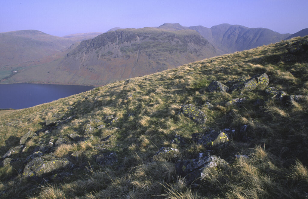ENGLAND, Cumbria, Lake District National Park. Early morning light illuminates the hills surrounding Wast Water
