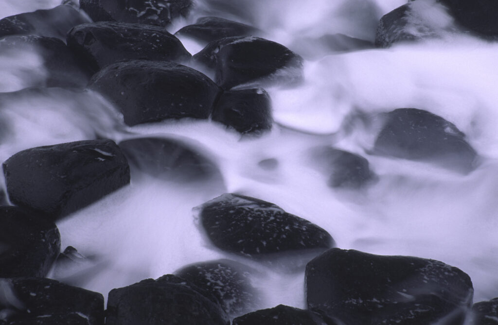 NORTHERN IRELAND, County Antrim, Giants Causeway. Waves crash against the hexagonal basalts rock formations of this world heritage site.