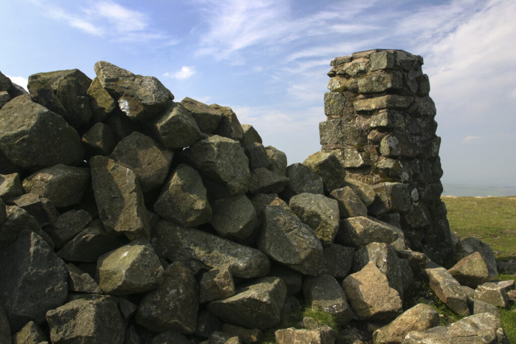 ENGLAND, Cumbria, Lake District National Park. A cairn marks the highest point of the cumbria way track at High Pike 658m