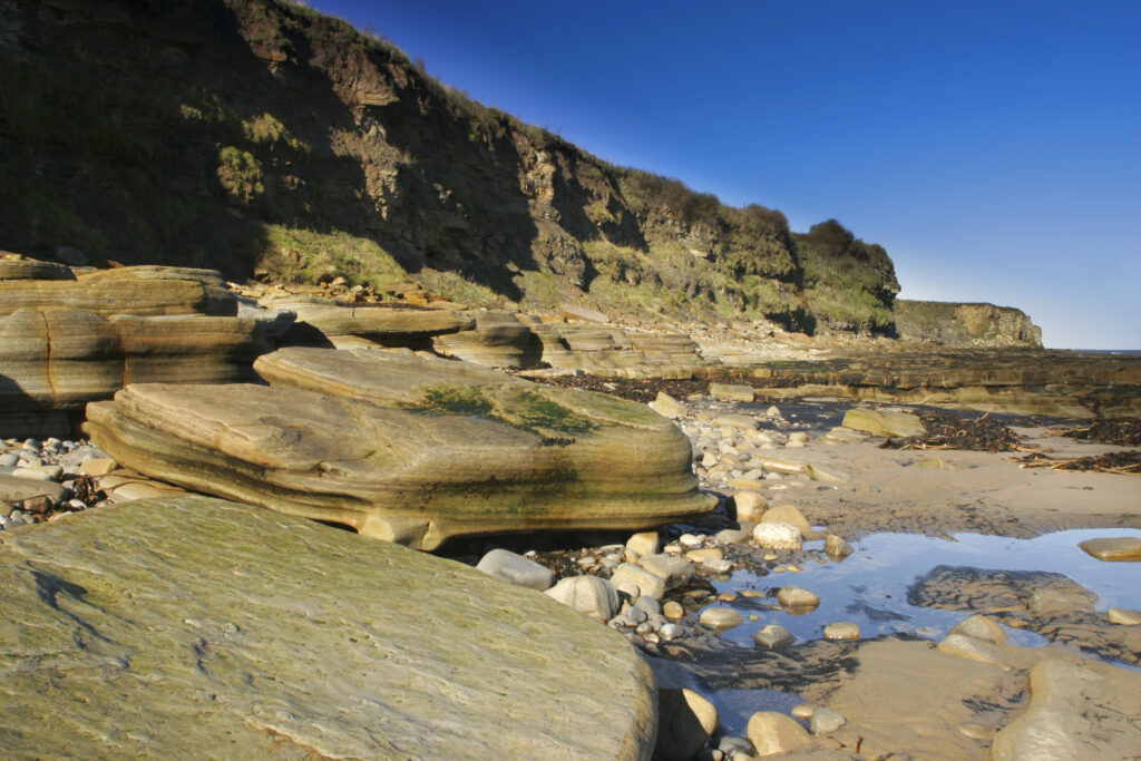 ENGLAND, Tyne & Wear, Whitley Bay. The rocky north tyneside coastline to be found north of the town