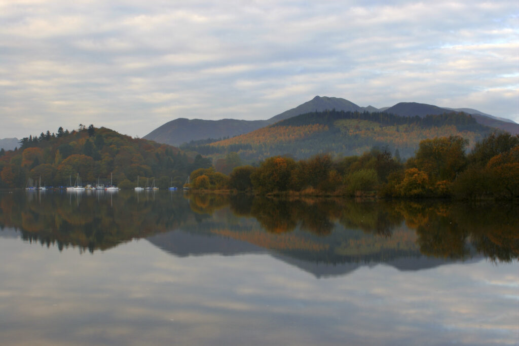 ENGLAND Cumbria Lake District National Park The pastel colours of dawn reflected in the still waters of Derwentwater